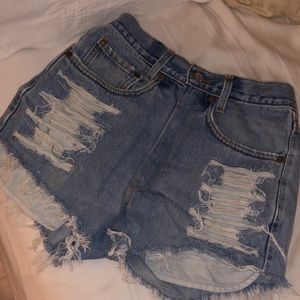 High waisted levi’s shorts with distressed pockets.